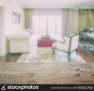 wooden table top with blur of luxury living room interior