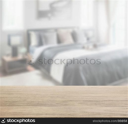 wooden table top with blur of modern bedroom in black and white color tone
