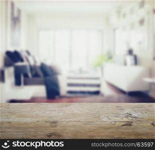 wooden table top with blur of modern bedroom interior