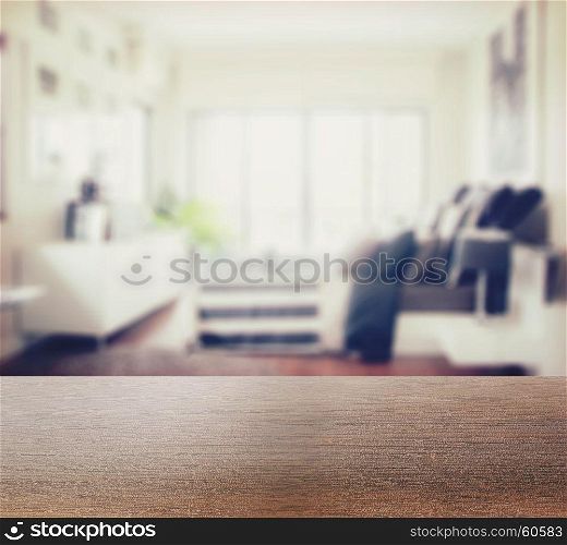 wooden table top with blur of modern bedroom interior as background