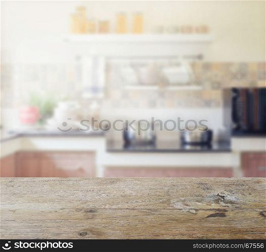 wooden table top with blur of modern kitchen interior for background