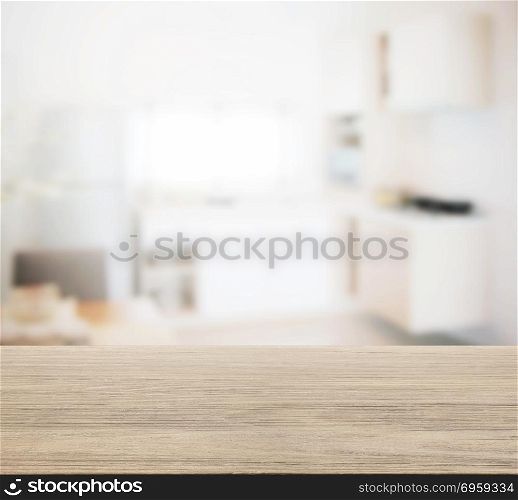 wooden table top with blur of modern kitchen interior for background. wooden table top with blur of modern kitchen interior for backgr