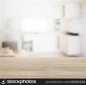 wooden table top with blur of modern kitchen interior for background. wooden table top with blur of modern kitchen interior for backgr