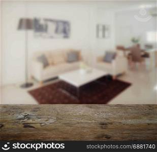 wooden table top with blur of modern living room interior
