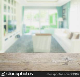wooden table top with blur of modern style living room interior