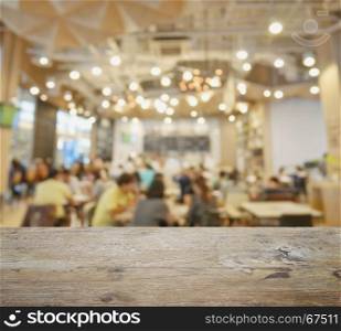 wooden table top with blur of restaurant and cafe as background