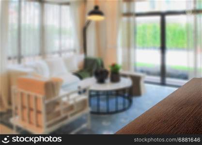 wooden table top with blurred background interior living room with decorative lamp