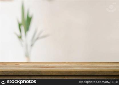 Wooden table top with blurred in coffee shop and cafe background for display montage, copy space.