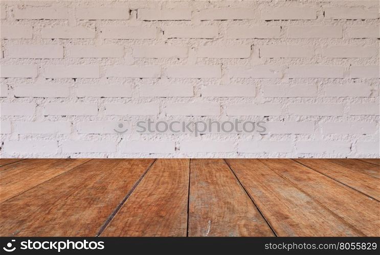 Wooden table top with brick wall decorated in coffee shop