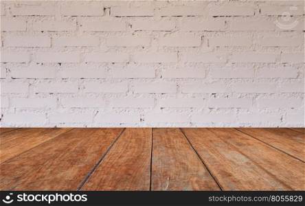 Wooden table top with brick wall decorated in coffee shop