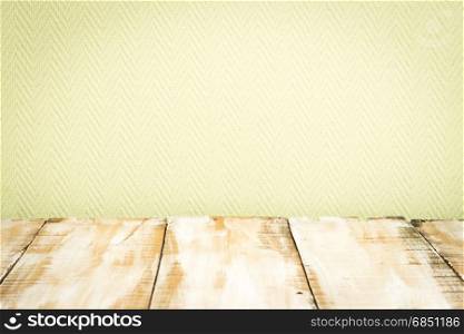 Wooden table top with green wall background