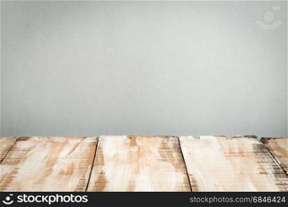 Wooden table top with grey wall background
