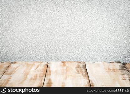 Wooden table top with grey wall background