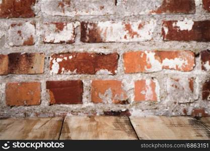 Wooden table top with Red brick wall background.