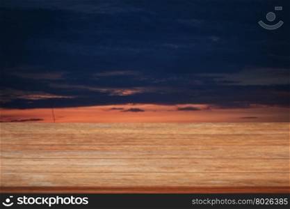 Wooden table top with sunrise on the lake with beautiful sky