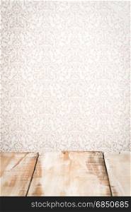 Wooden table top with vintage style wall background.