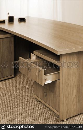 wooden table with an open box in the office
