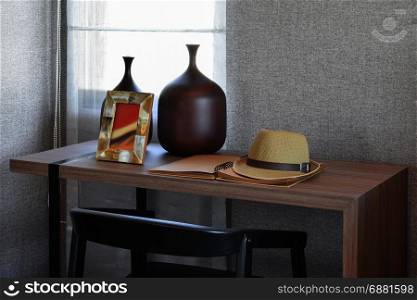 wooden table with black chair and books in modern working area at home