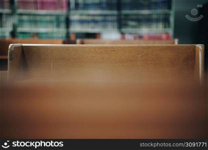 wooden table with bookshelf for reading in library interior