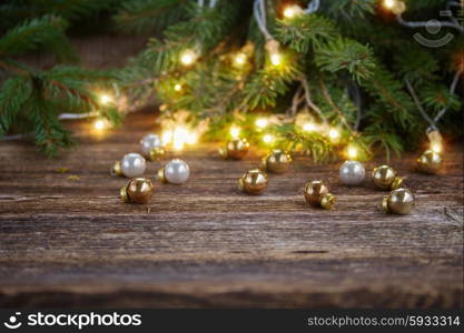 wooden table with christmas tree, defocused christmas lights and glass decorationd