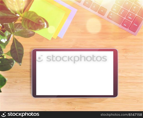 wooden table with tablet pc and office related objects, modern stylish work place, view from above