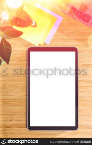 wooden table with tablet pc and office related objects, modern stylish work place, view from above