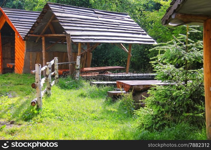 Wooden tables and benches in the gazebo at the park