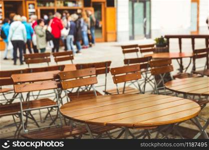 Wooden tables in outdoor cafe, Karlovy Vary, Czech Republic, Europe. Old european town, famous place for travel and tourism