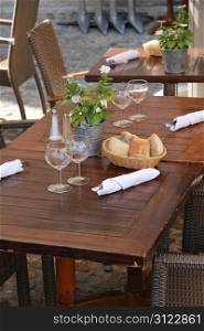 Wooden tables with napkins and cutlery at a restaurant