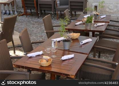 Wooden tables with napkins and cutlery at a restaurant