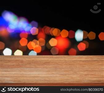 Wooden tabletop with abstract night lights, stock photo