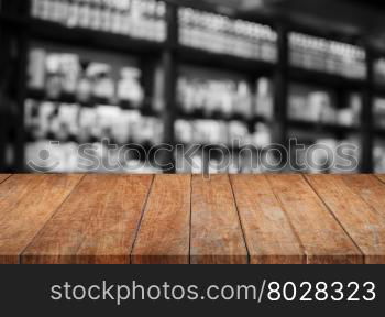 Wooden tabletop with black and white cafe blurred background, stock photo