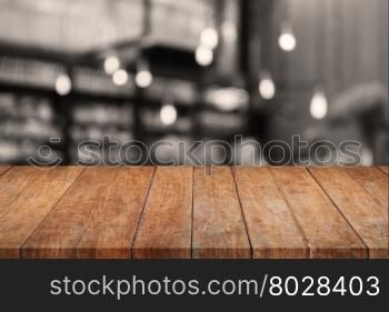 Wooden tabletop with sepia coffee shop blurred background, stock photo