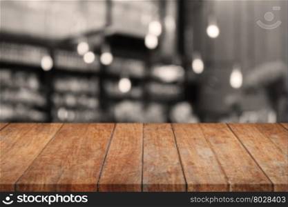 Wooden tabletop with sepia coffee shop blurred background, stock photo