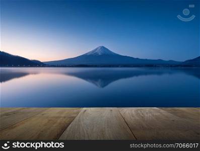 wooden terrace and mountain fuji with reflection at lake kawaguchiko in the morning