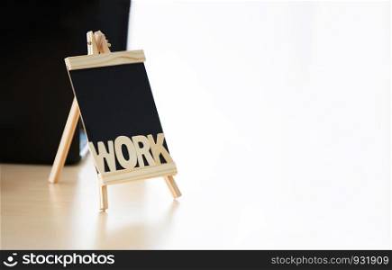 wooden text word of WORK on blackboard minimal style on desk
