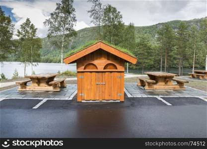 wooden toilet building and benches as a resting place on a fjord in Norway. wooden toilet building and benches as a resting place