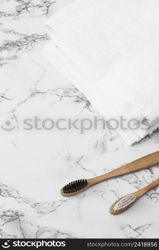 wooden toothbrush white towels marble surface