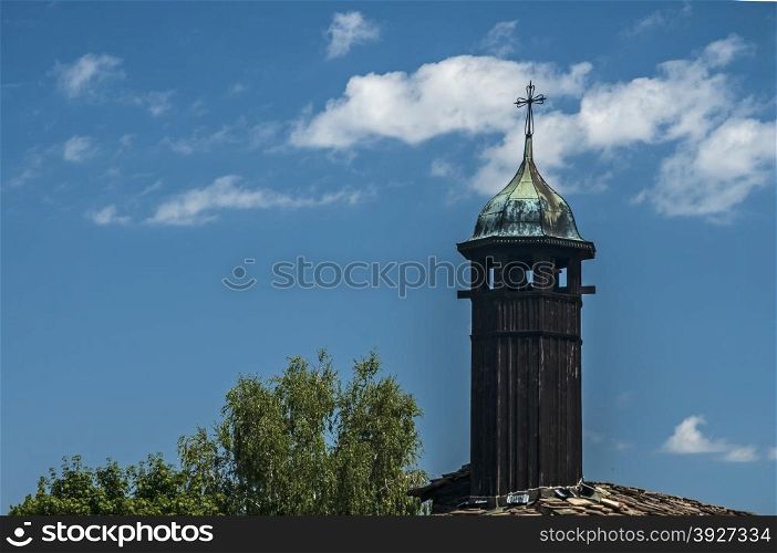 Wooden tower on old orthodox church on blue sky background