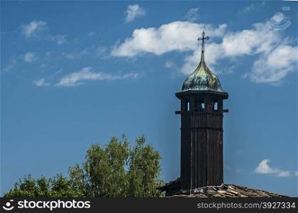 Wooden tower on old orthodox church on blue sky background
