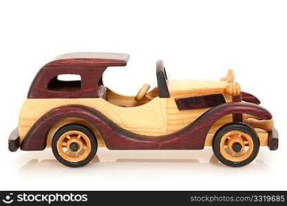 Wooden toy car over white background with reflection. Natural and stained wood.