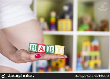 Wooden toy cubes, Baby. Wooden toy cubes with letters, Baby, Pregnancy concept
