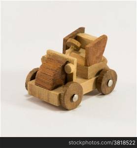 Wooden toy old car miniature isolated on white background