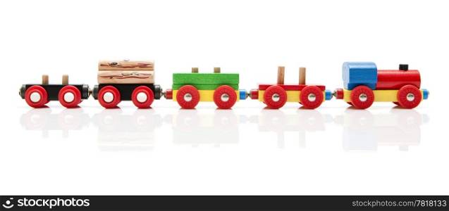 Wooden toy train with a locomotive and four carriages, half unloaded from left to right with a subtle reflection on a white background
