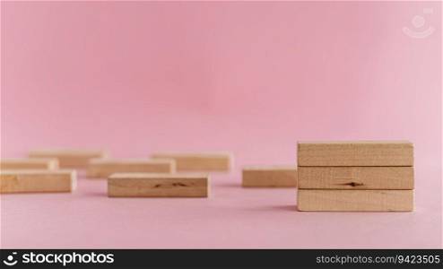 Wooden toys arranged on pink background for leisure activities concept