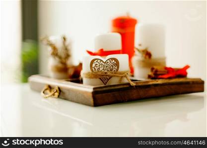 Wooden tray with candles decorated with a heart