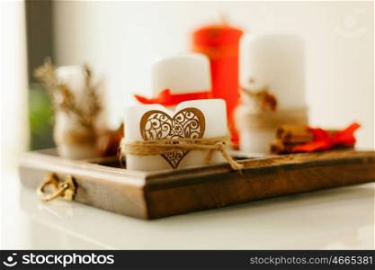 Wooden tray with candles decorated with a heart