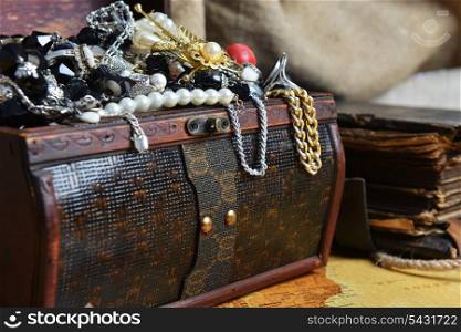 Wooden treasure chest with valuables. beads, necklaces and other jewelry