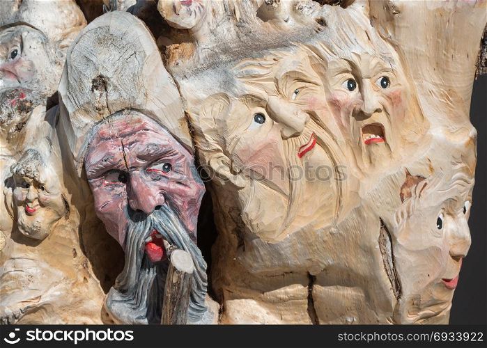 Wooden Tree Sculpture: Close-up of Faces Carved in Wood, Handmade. Wooden Tree Sculpture: Close-up of Faces Carved in Wood, Handmad