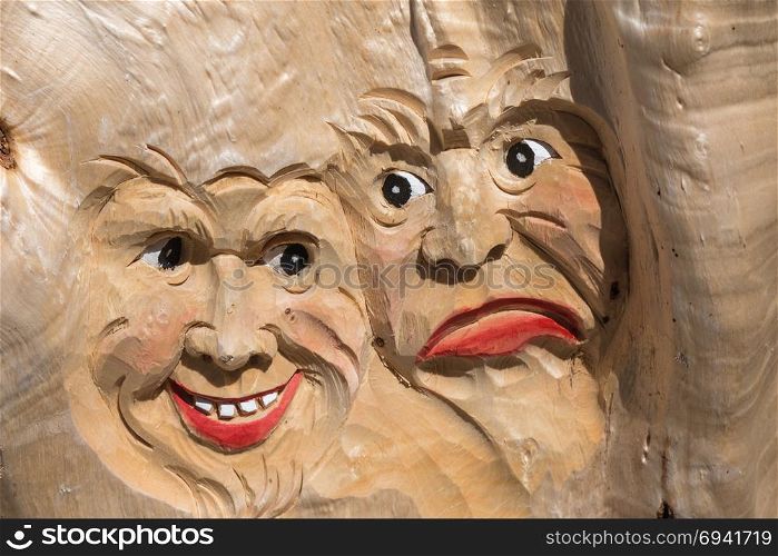 Wooden Tree Sculpture: Close-up of Faces Carved in Wood, Handmade.. Wooden Tree Sculpture: Close-up of Faces Carved in Wood, Handmade